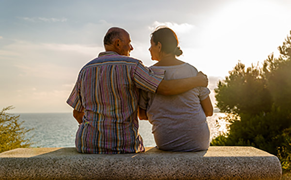 couple sitting on a bench overlooking a lake