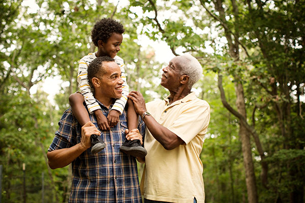 Three generations walking on a trail
